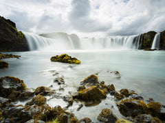 Misty waterfall photographed from the water