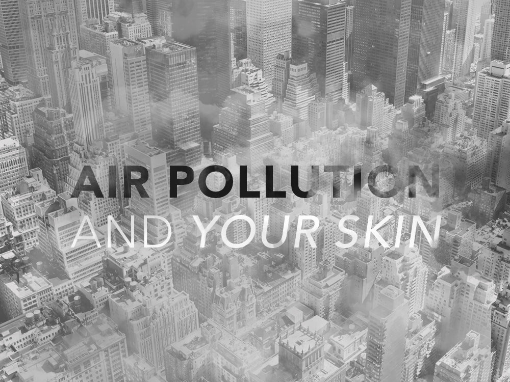 Black and white photo of a city with the text “Air Pollution and Your Skin”
